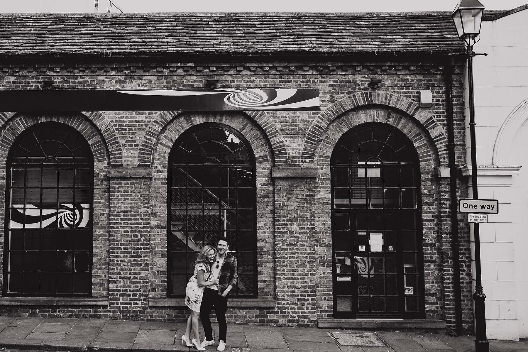 engaged couple laughing and hugging during their pre wedding photo shoot in Leeds