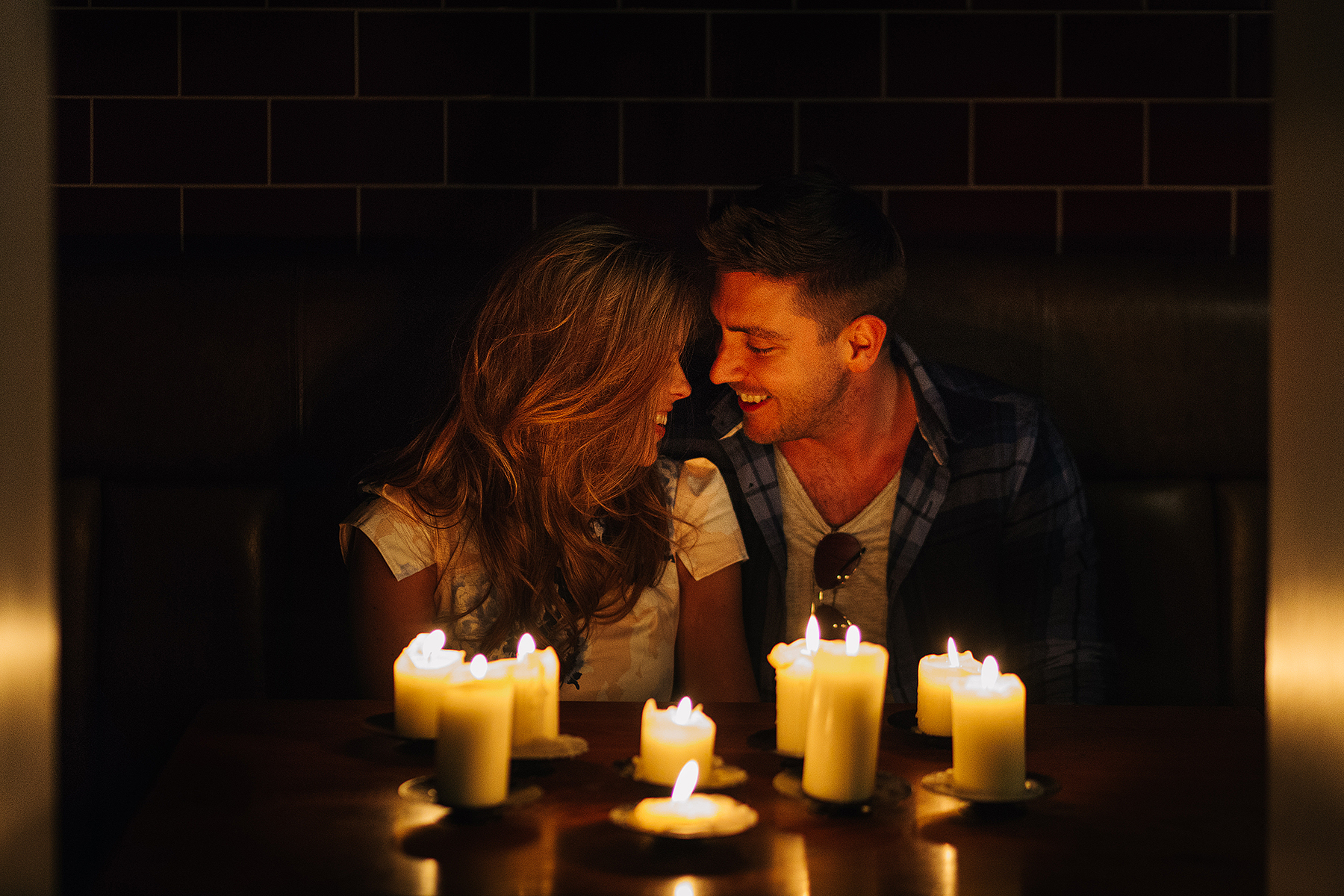 Couple like by candlelight in Jake's bar in Leeds