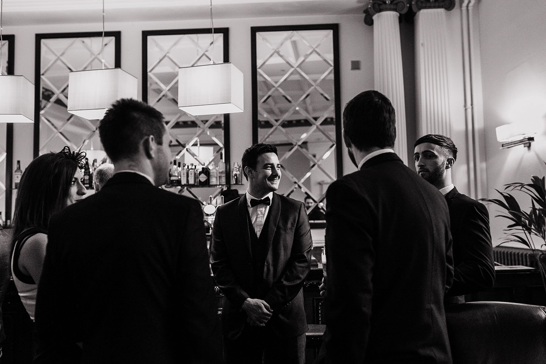A groom in bow tie stood by the bar at Lost and Found Leeds Club