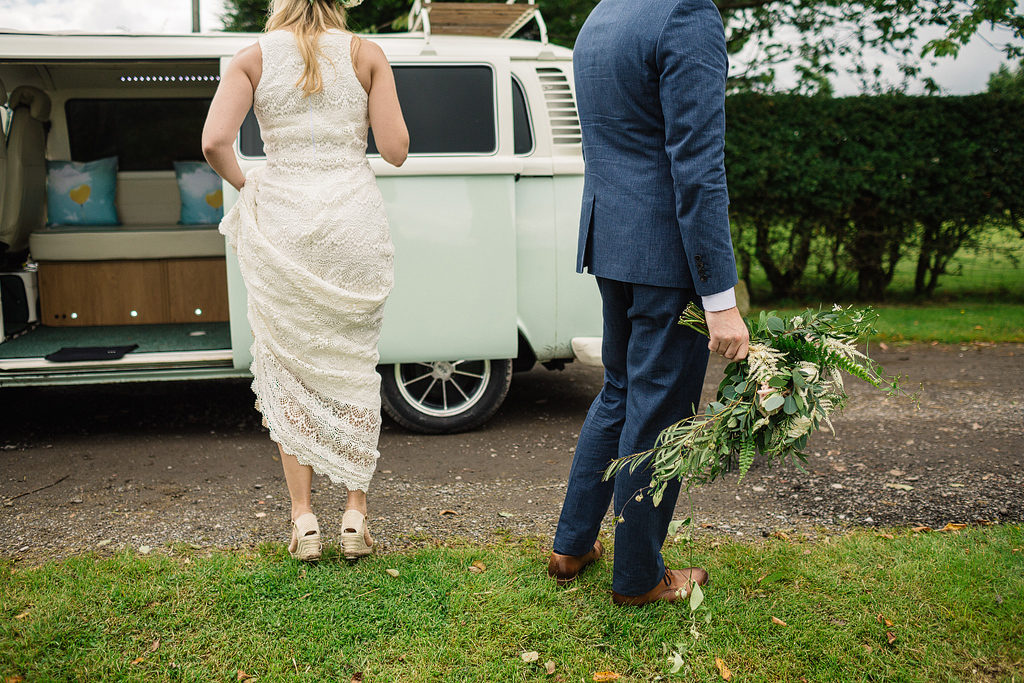 bride and groom with a campervan at tipi wedding