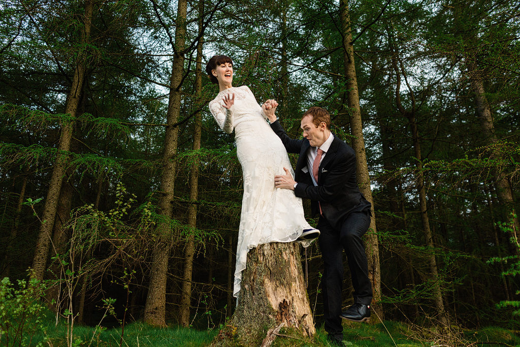 bride and groom having fun in the lake district on their wedding day