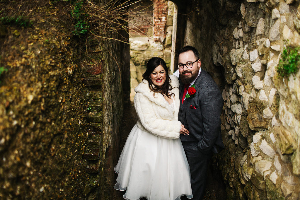 bride and groom wedding pictures in the rain at farnham castle