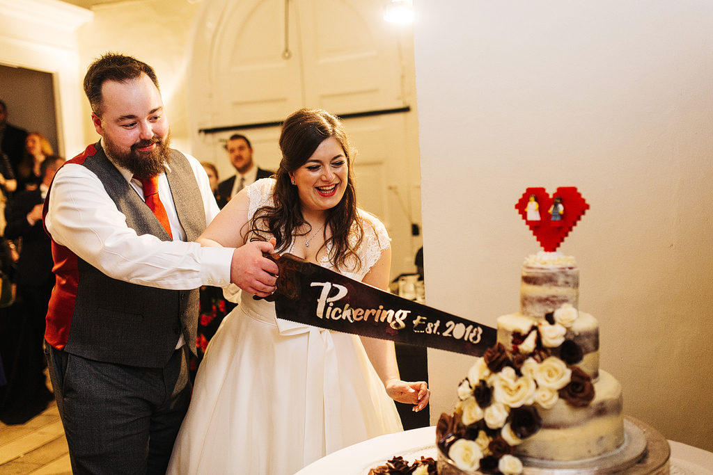 quirky cake cutting at farnham castle wedding