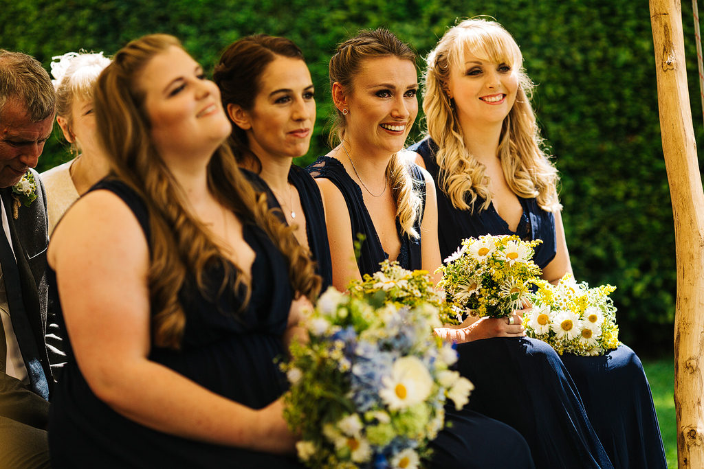 bridesmaids at an outdoor ceremony wearing navy
