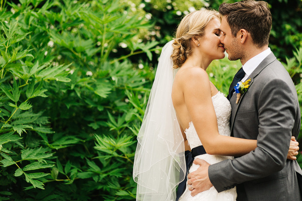 couple kissing at their country house spring outdoors wedding