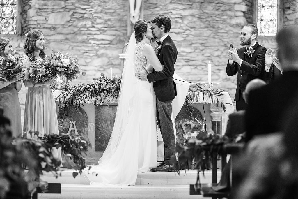 bride and groom kiss at st michael s church sneem