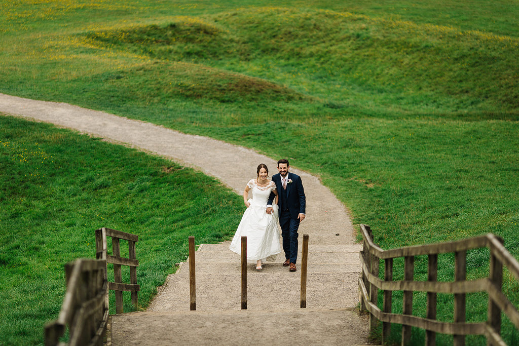 photos of a bride and grrom walking to tithe barn bolton abbey