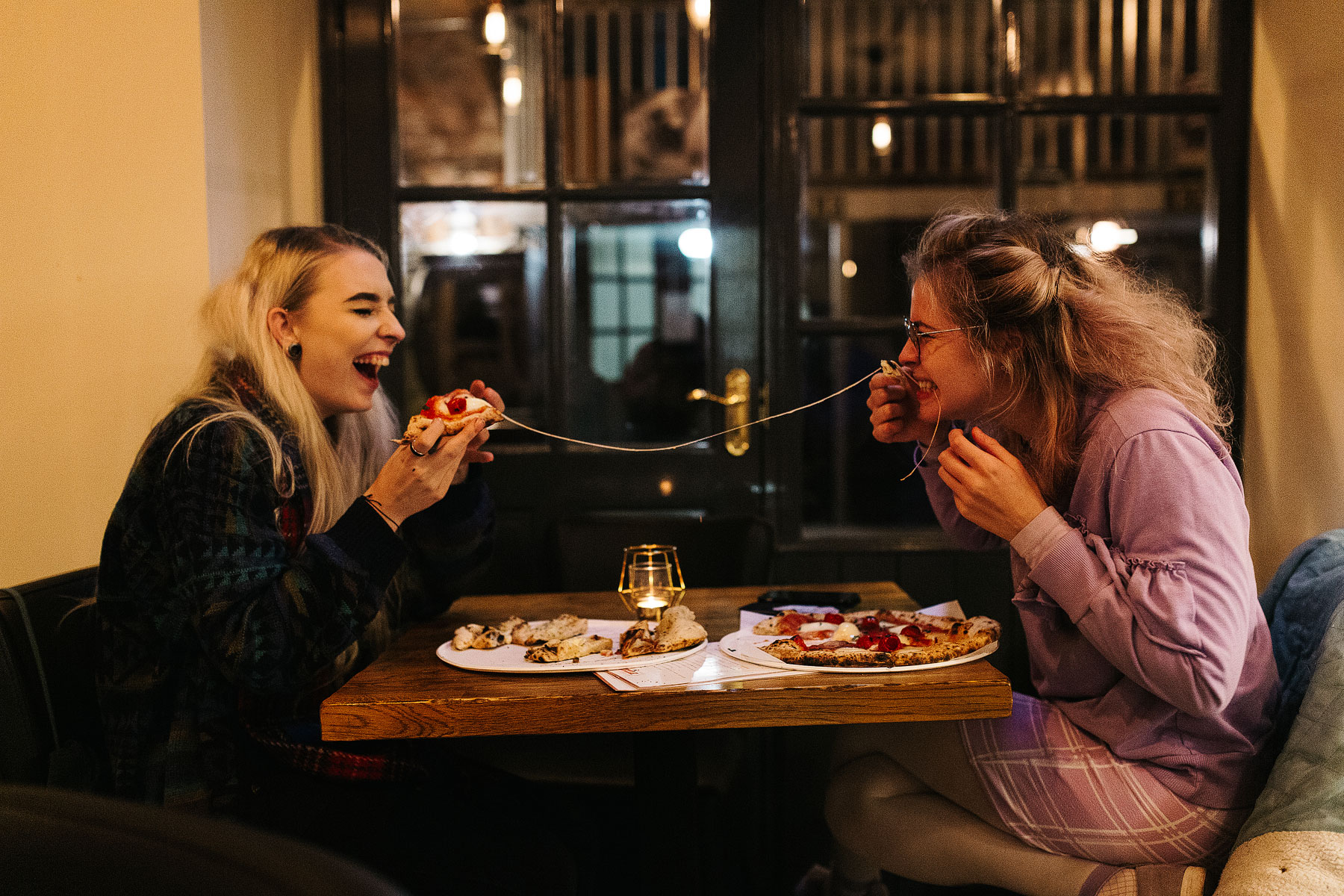 girls eating pizza on pizza loco opening night in sunbridge wells