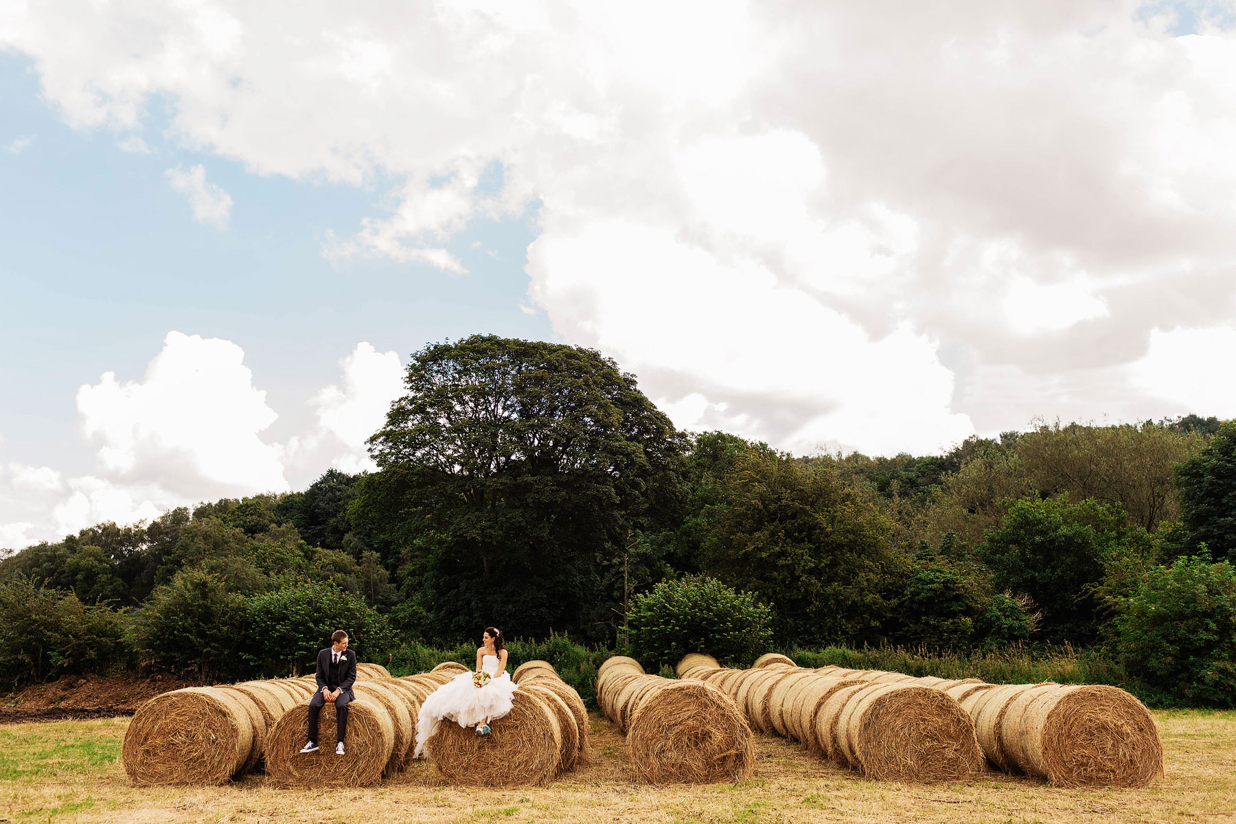 bride and groom on haybales