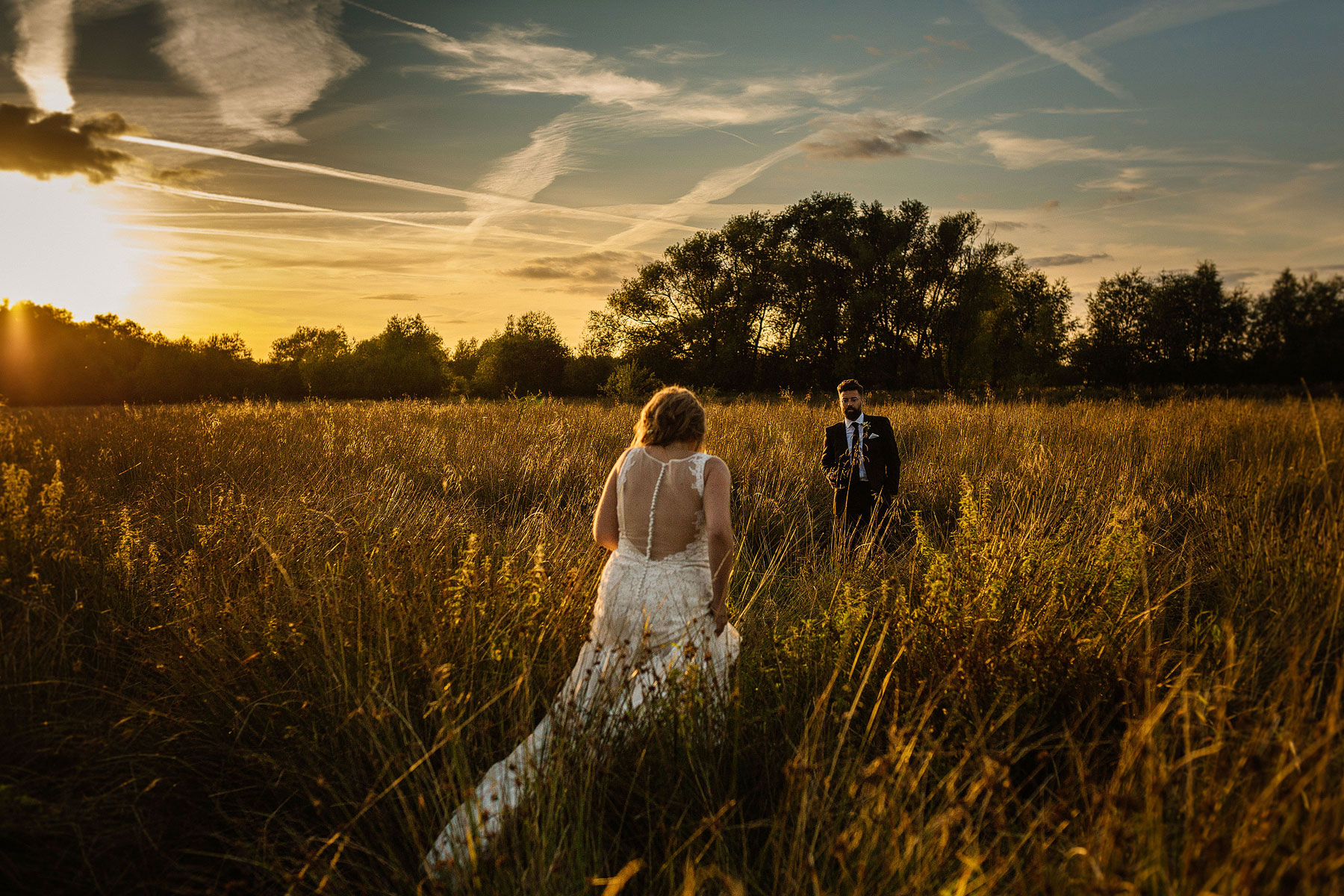 bride and groom in leicester golden hour in a field