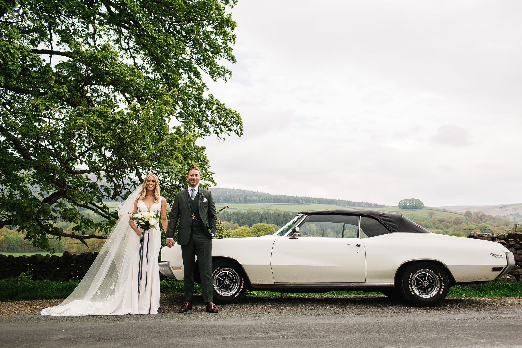 bride and groom with a wedding car at barden tower