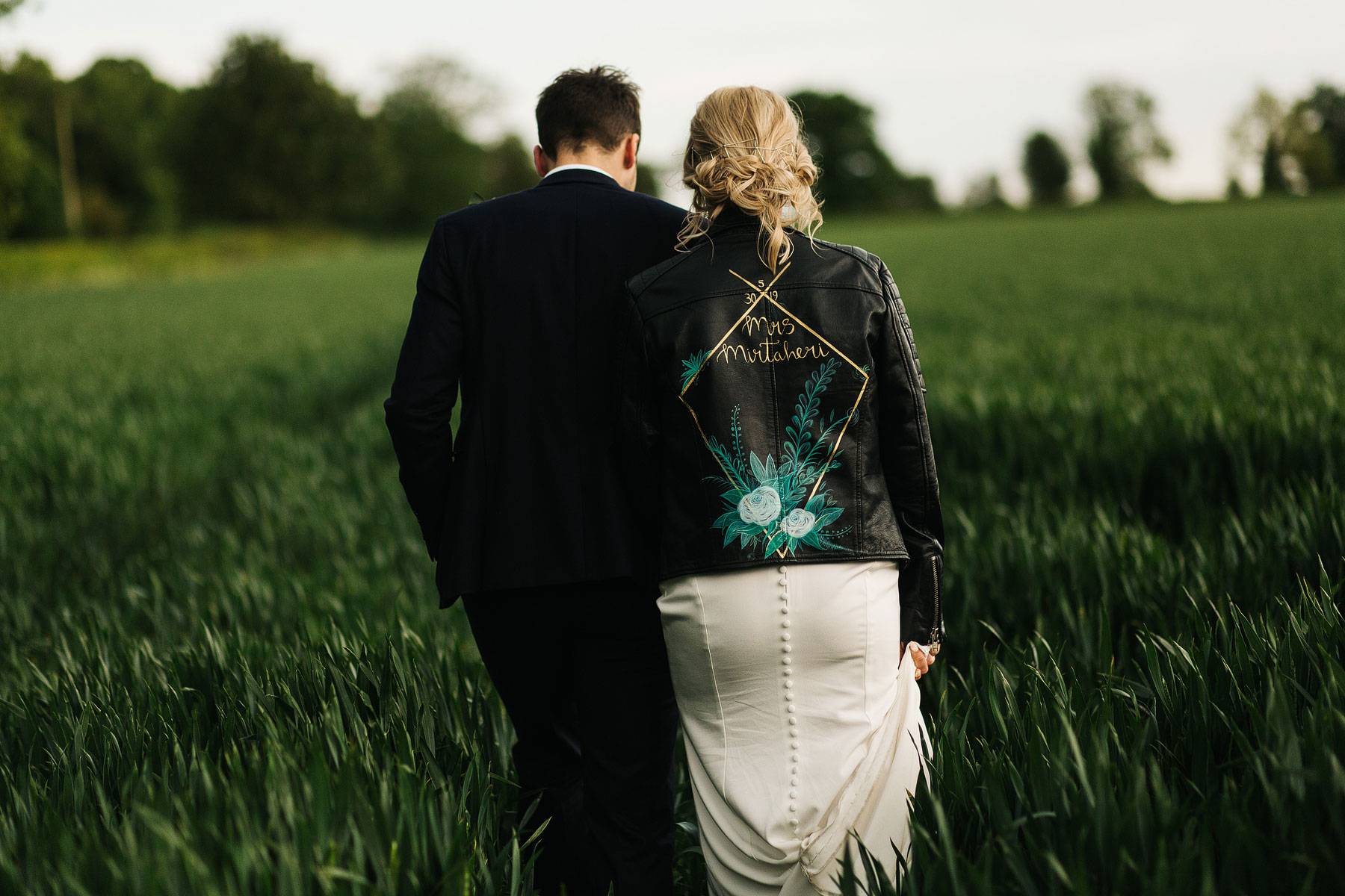 bride and groom walking through cornfields in york