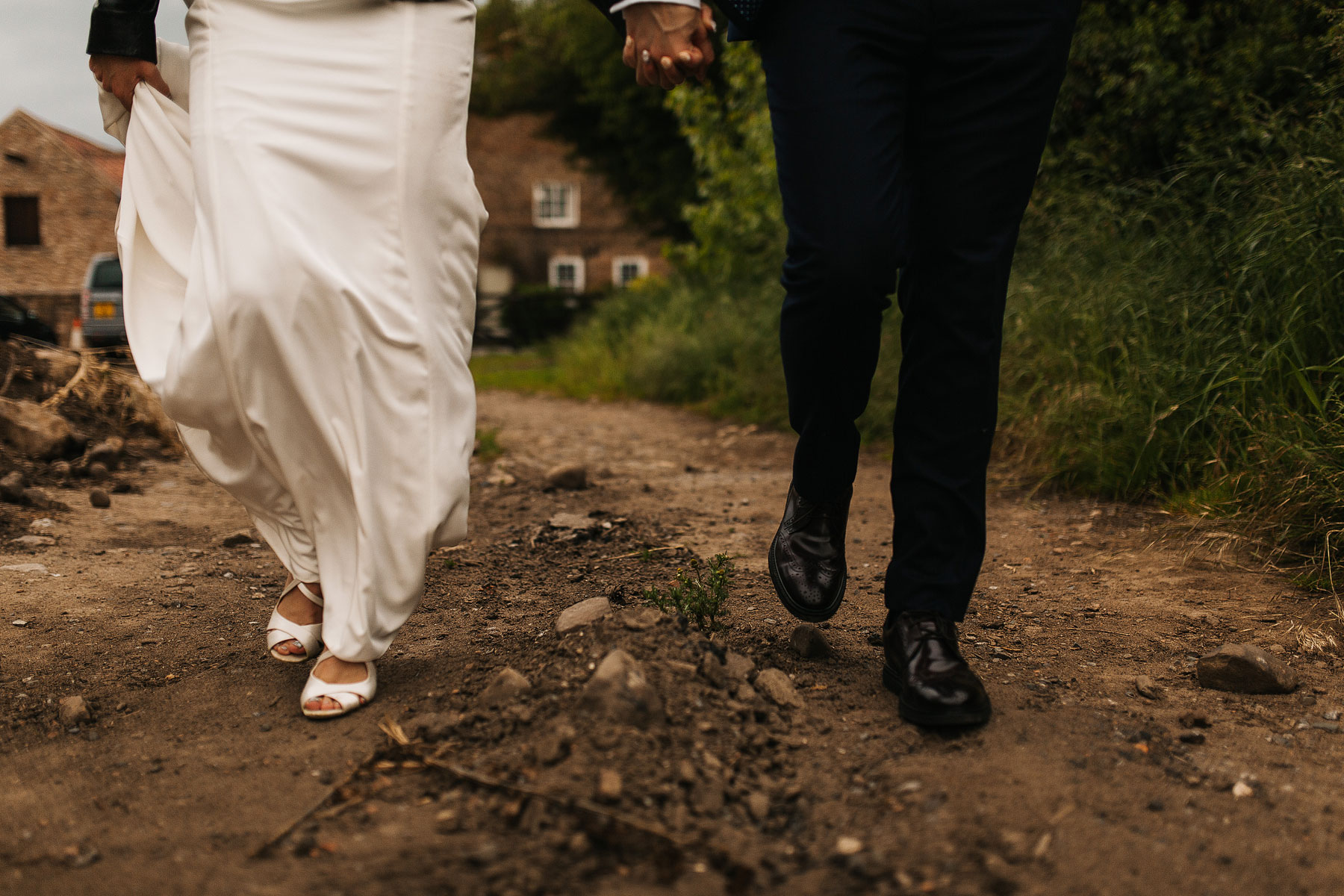 bride and groom walking to theor persian wedding in york Normans Barn Wedding