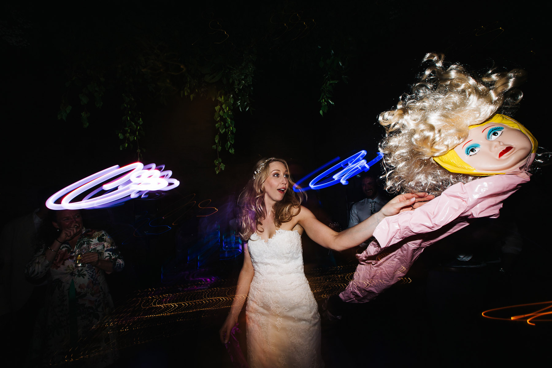 Bride holding a blow up doll 