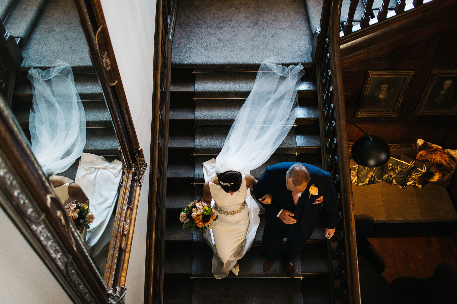 bride walking the stairs to her wedding at ellingham hall