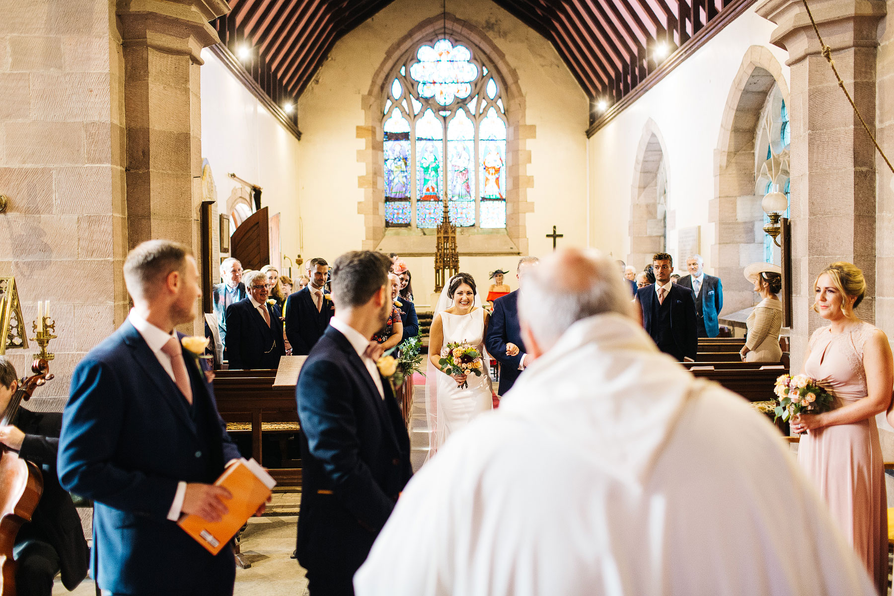 bride entering the church at ellingham hall in northumberland near seahouses