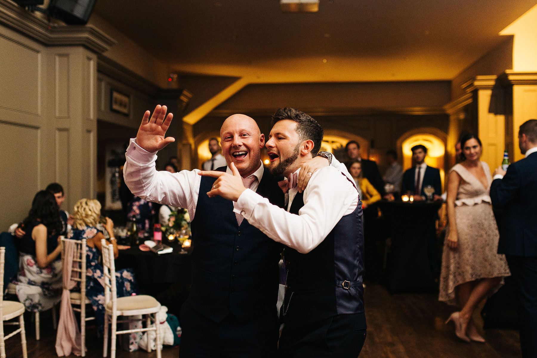 groom and friend dancing to wedding band