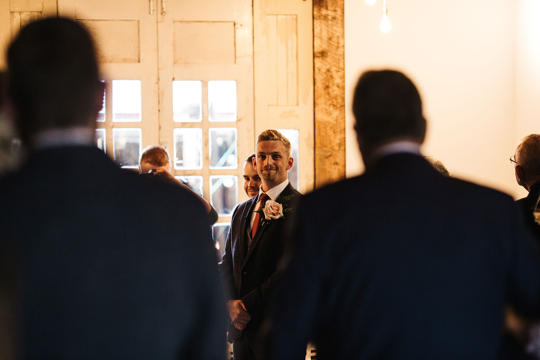 groom sees beide for the first time in a barn wedding