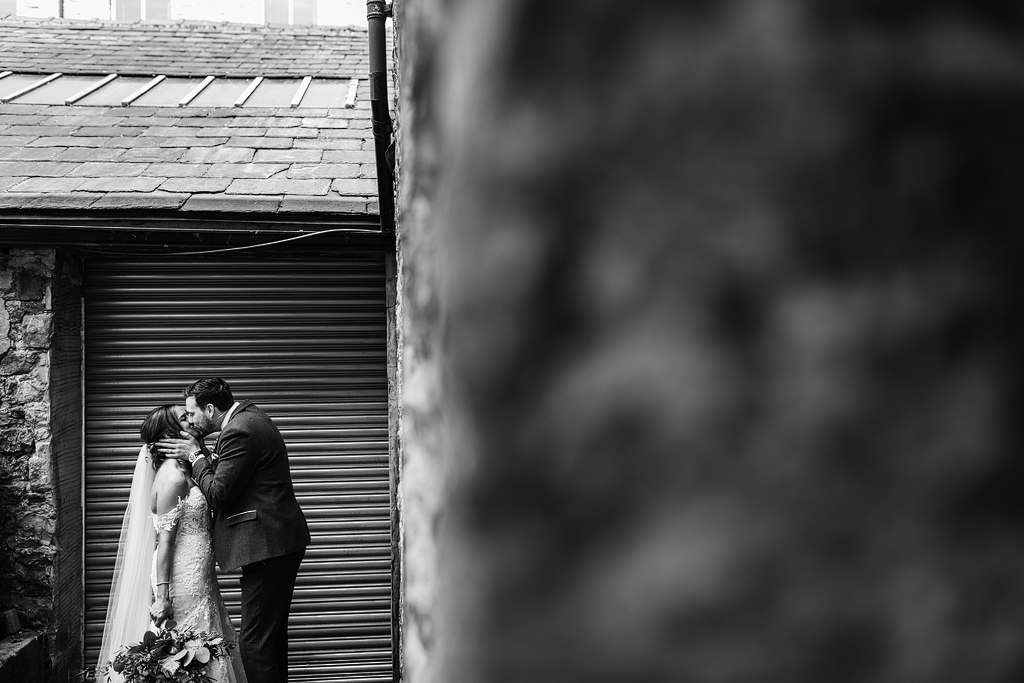 bride and groom having a romantic moment at holmes mill