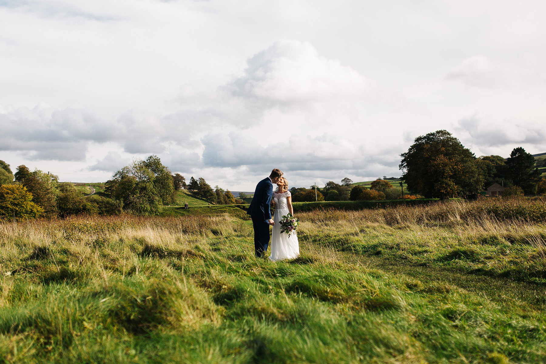 bride and groom in a field near linton falls