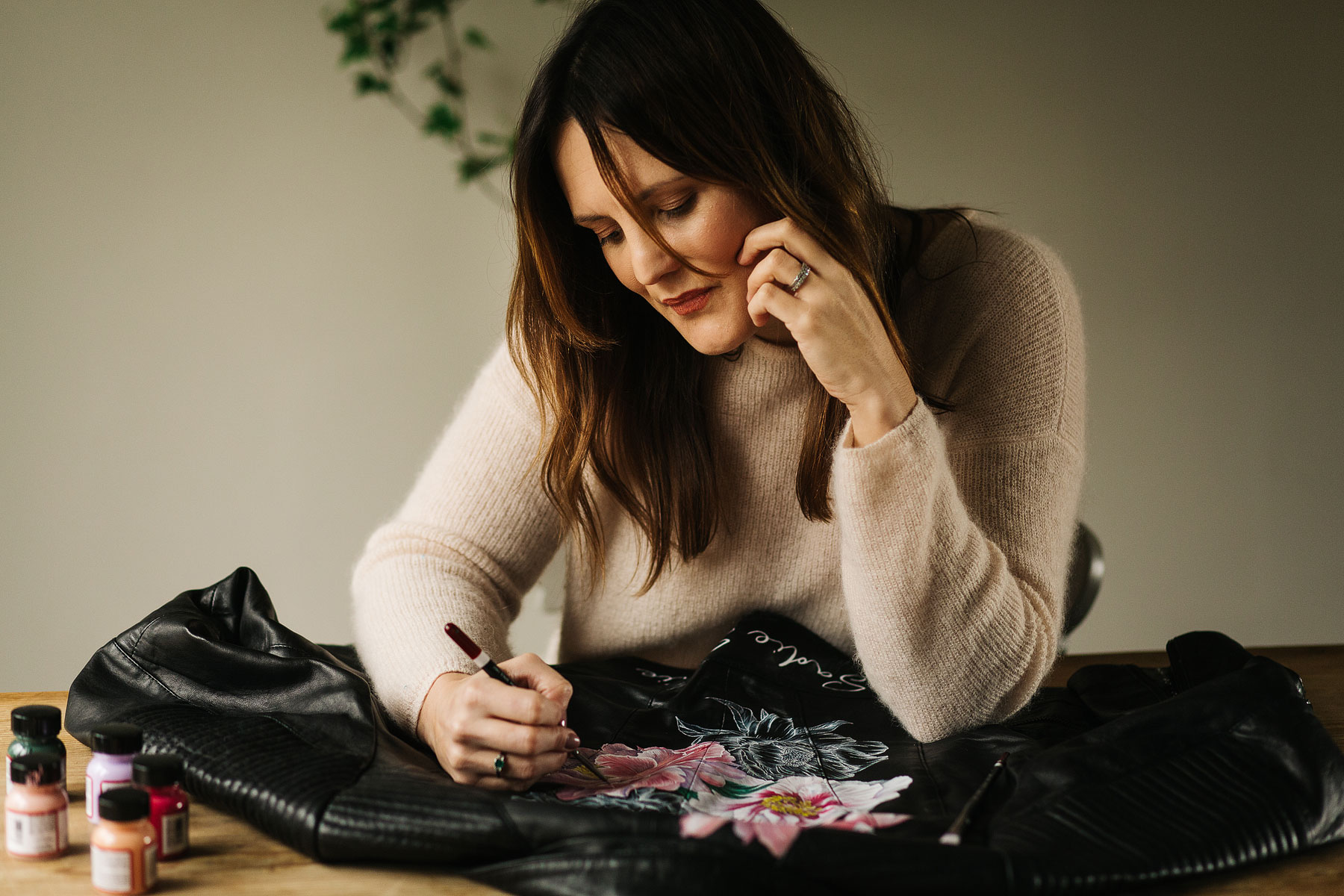 kate painting a wedding jacket for her small business commercial shoot