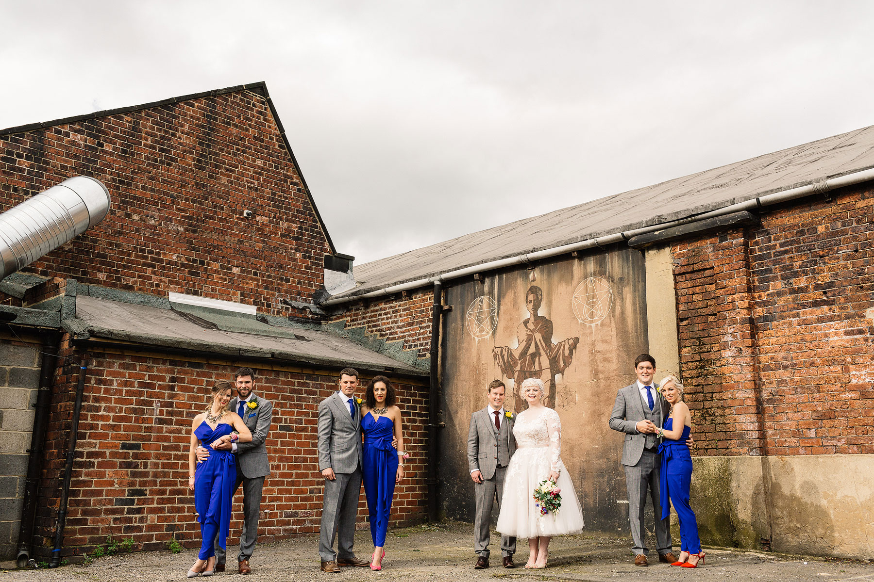 bridemaids in electric blue wedding jumpsuits
