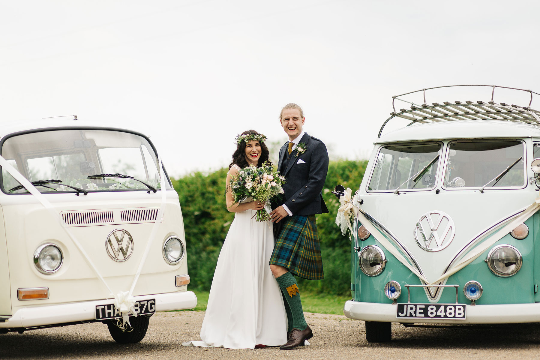 bride and groom with their vw wedding campervan transport