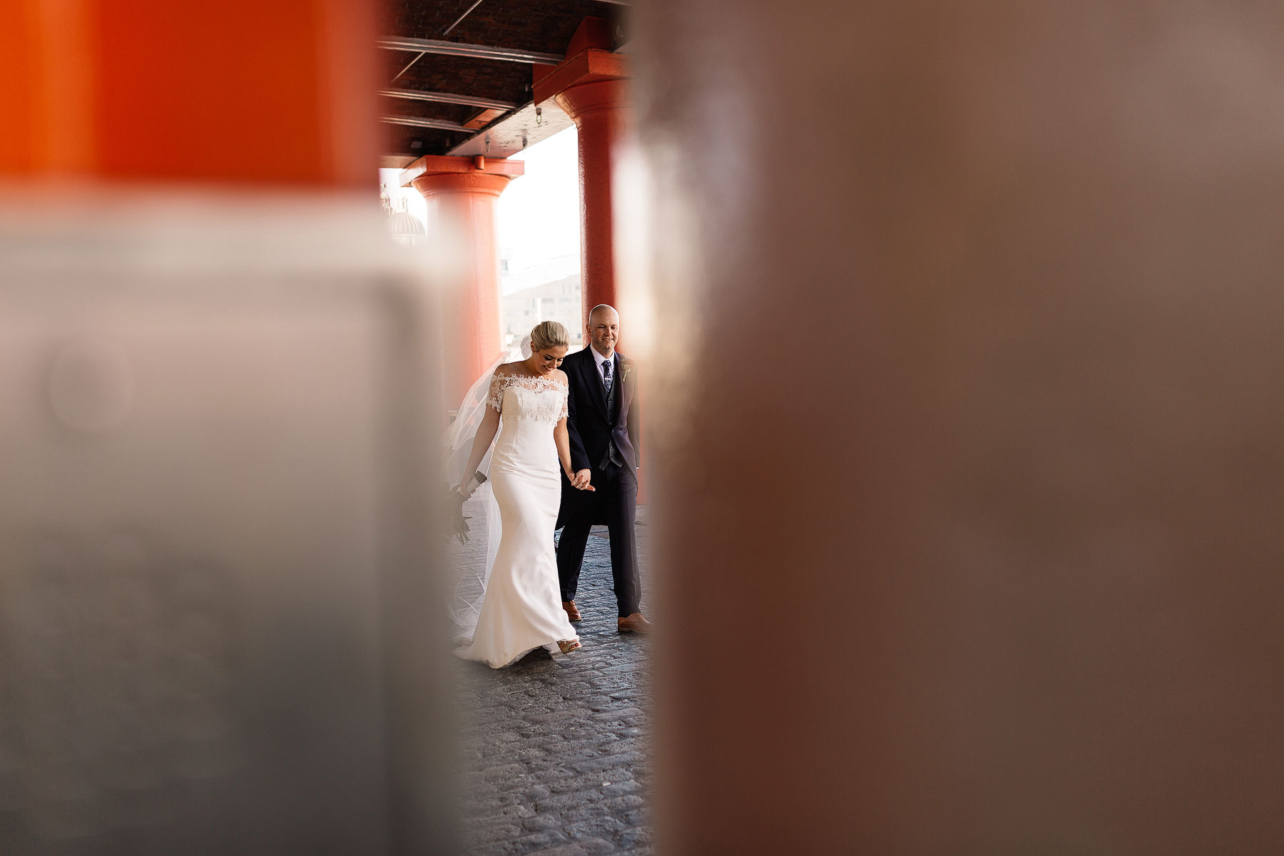 informal wedding photos bride and groom walking around the albert docks