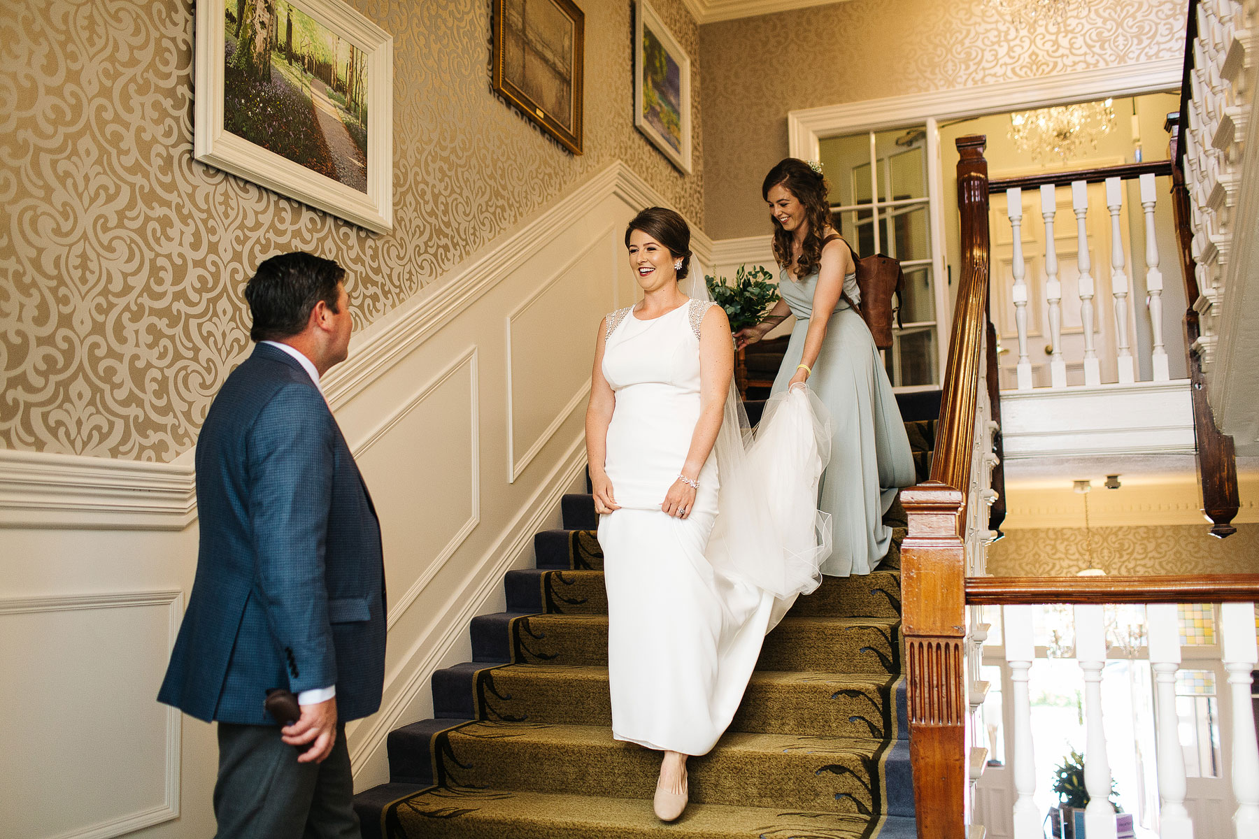 bride walking down the stairs of her hotel to get married in ireland