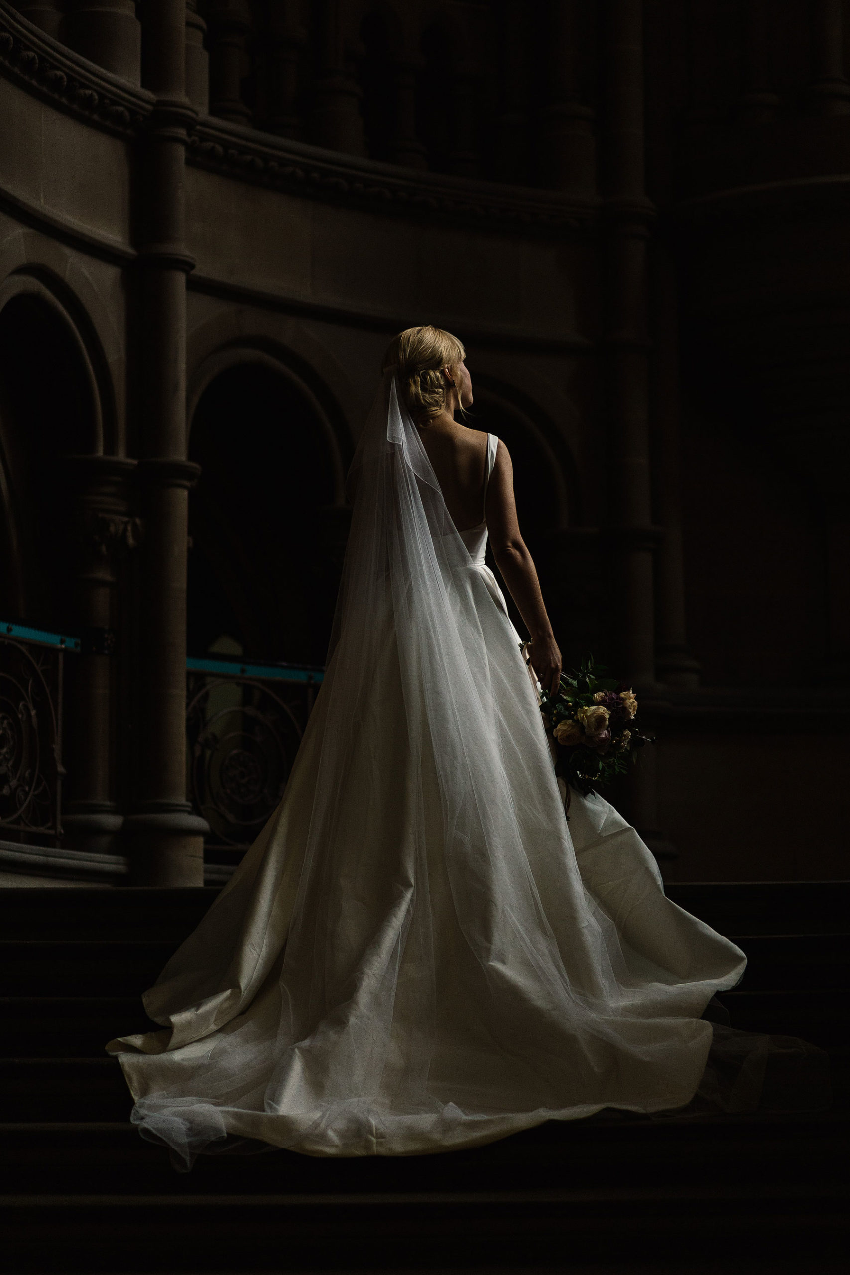 bride stood on the stairs at manchester town hall