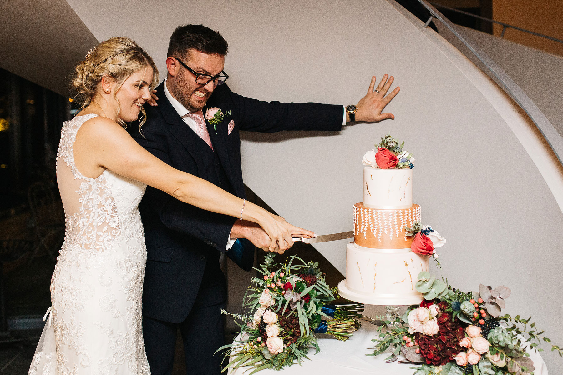 bride and groom cutting their wedding cake at blackwell grange in warwickshire