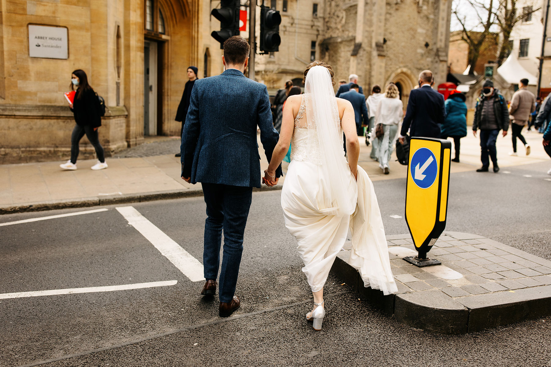 bride and groom walking through the streets of oxford