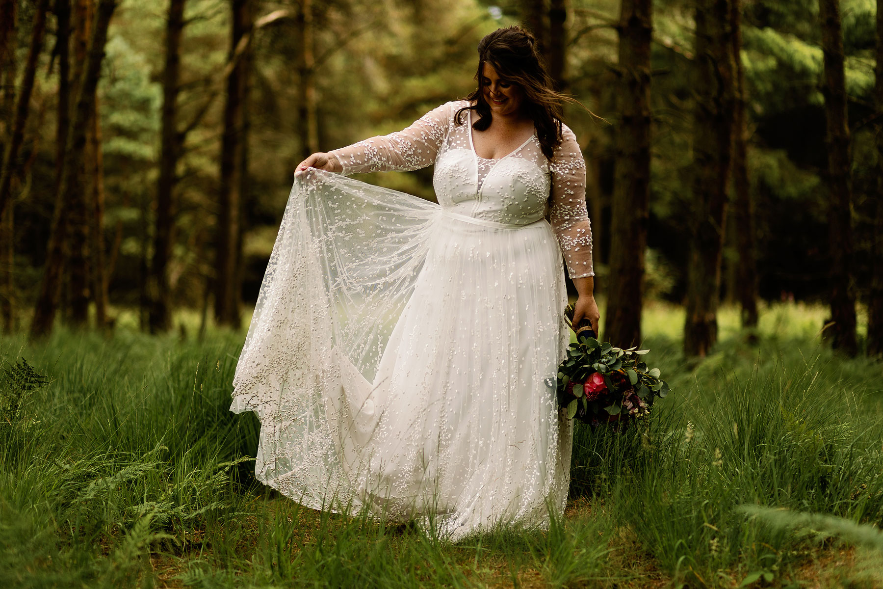 bride in the woods in her wedding dress