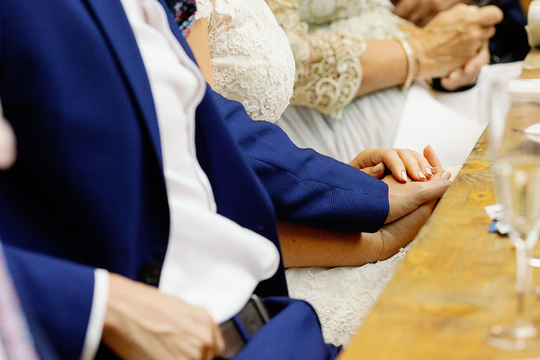 holding hands at a wedding
