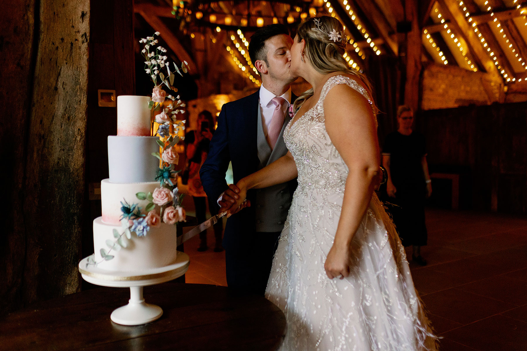 bride and groom cutting the cake in north yorkshire at a barn wedding