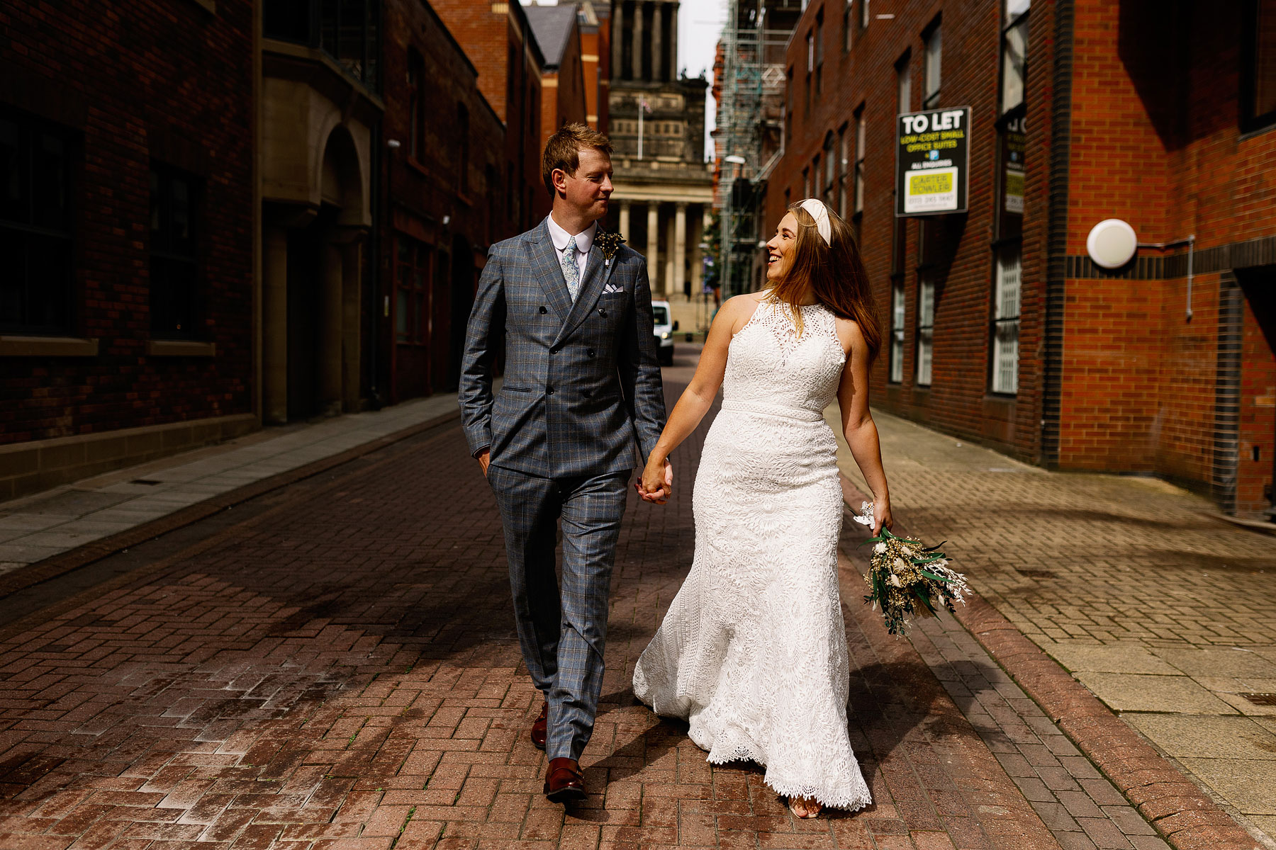 bride and groom walking in leeds