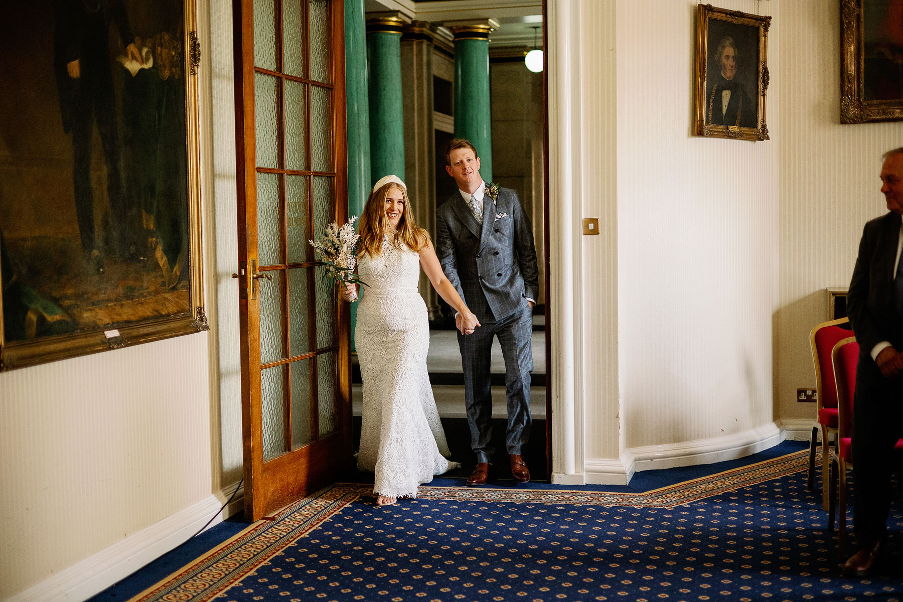 bride and groom entering their wedding ceremony at leeds civic hall