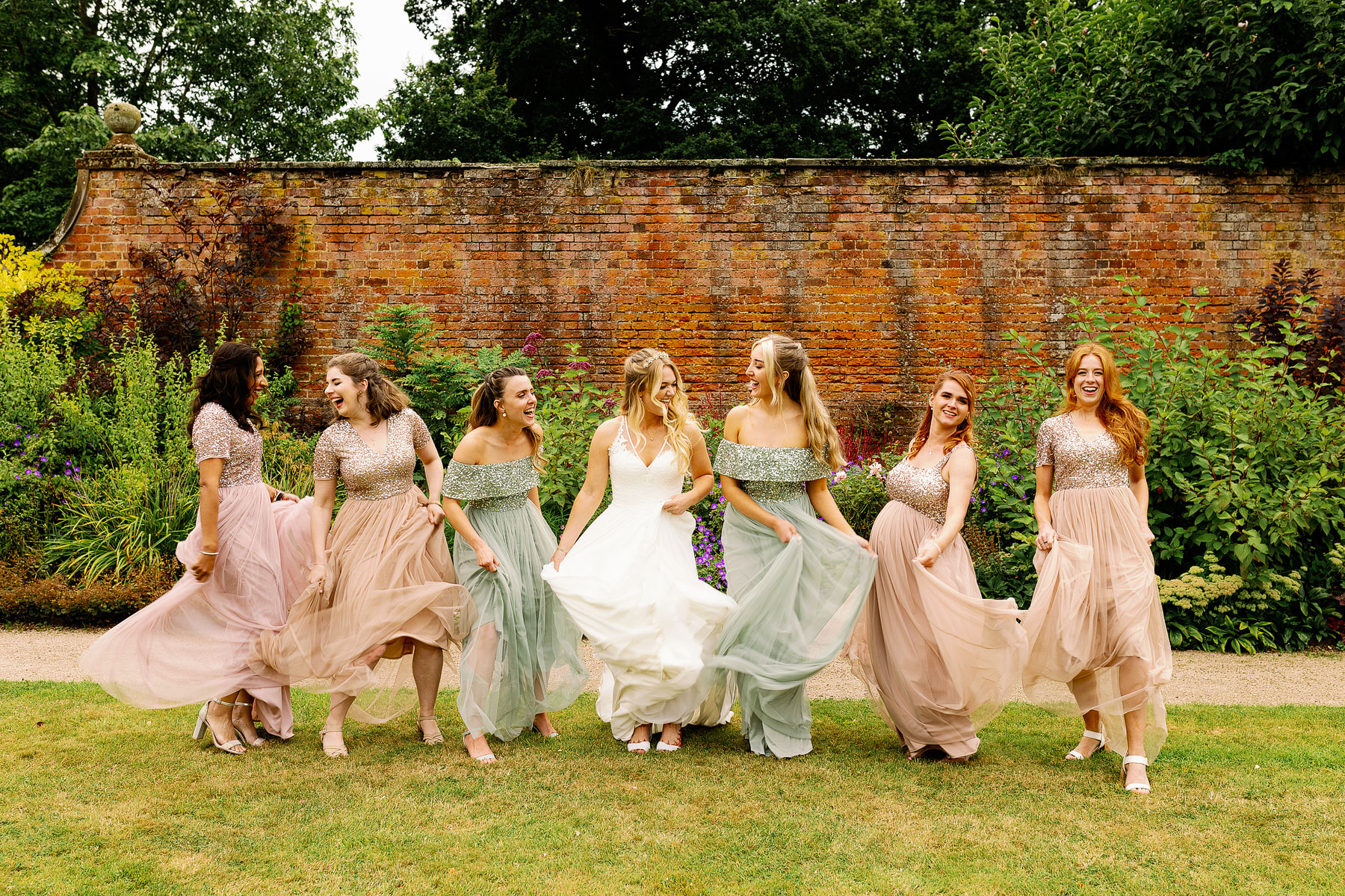 bridesmaids wearing geen and peach sparkles for a garden wedding