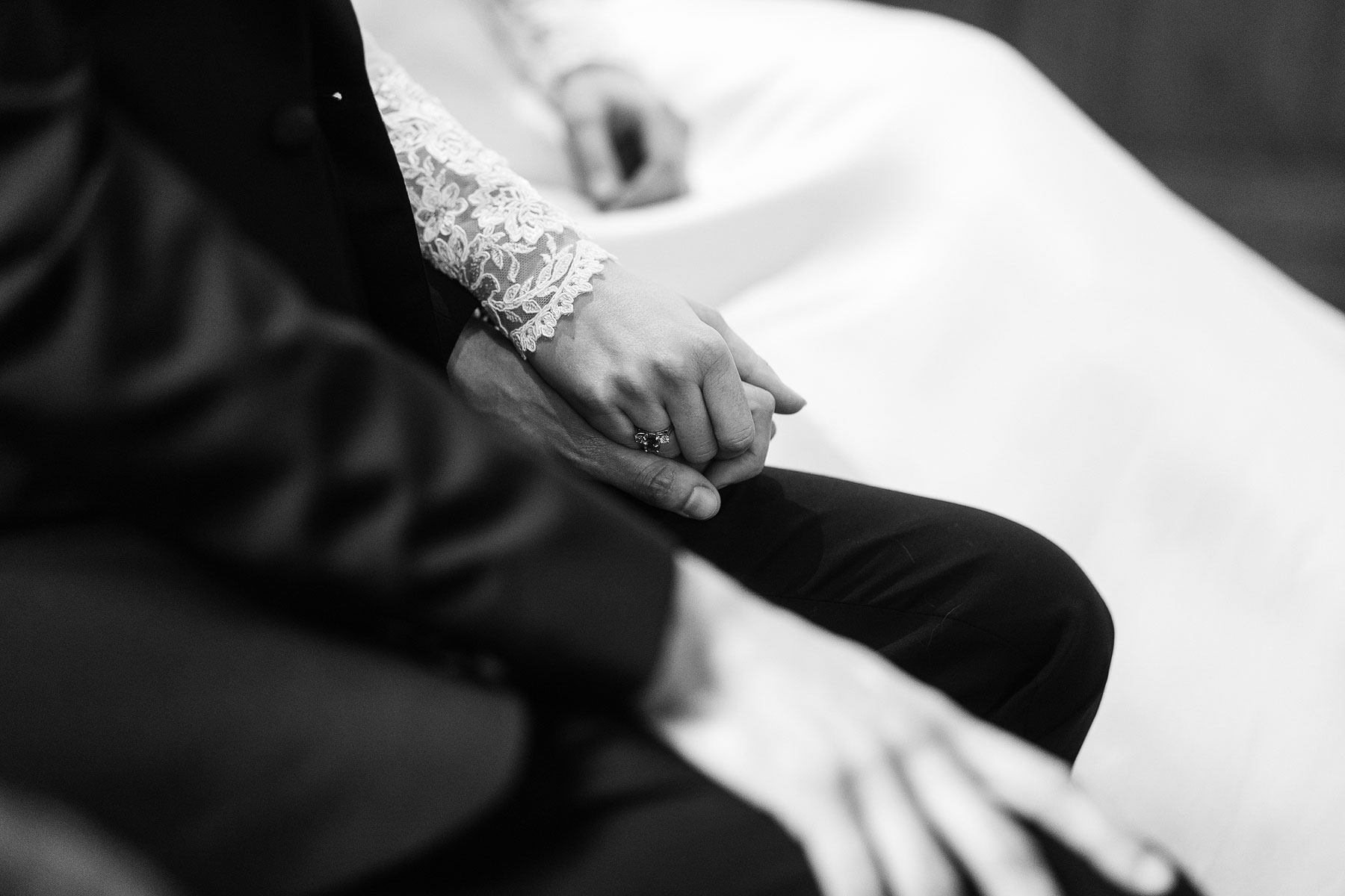 bride and groom holding hands in church