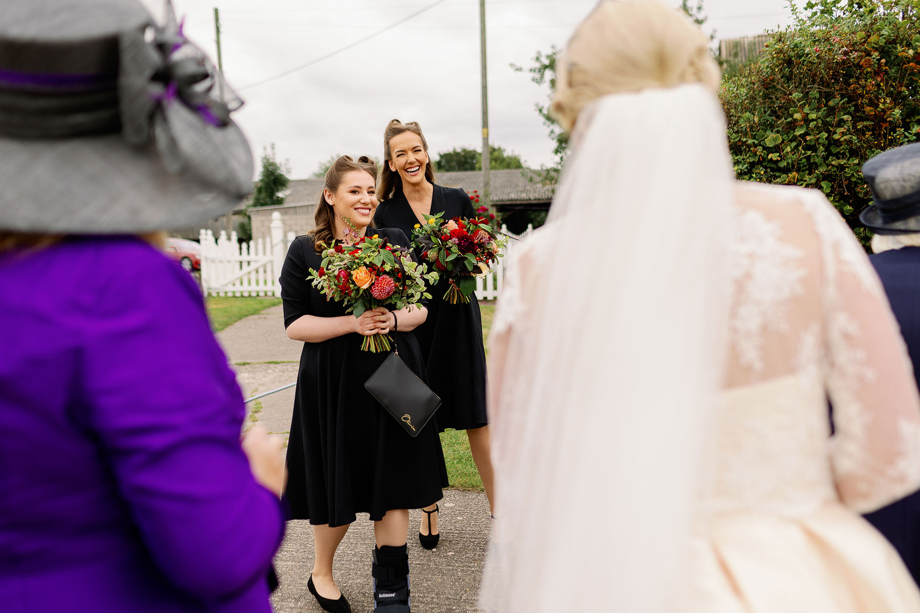 bridesmaid wearing black with amazing autumn bouquets