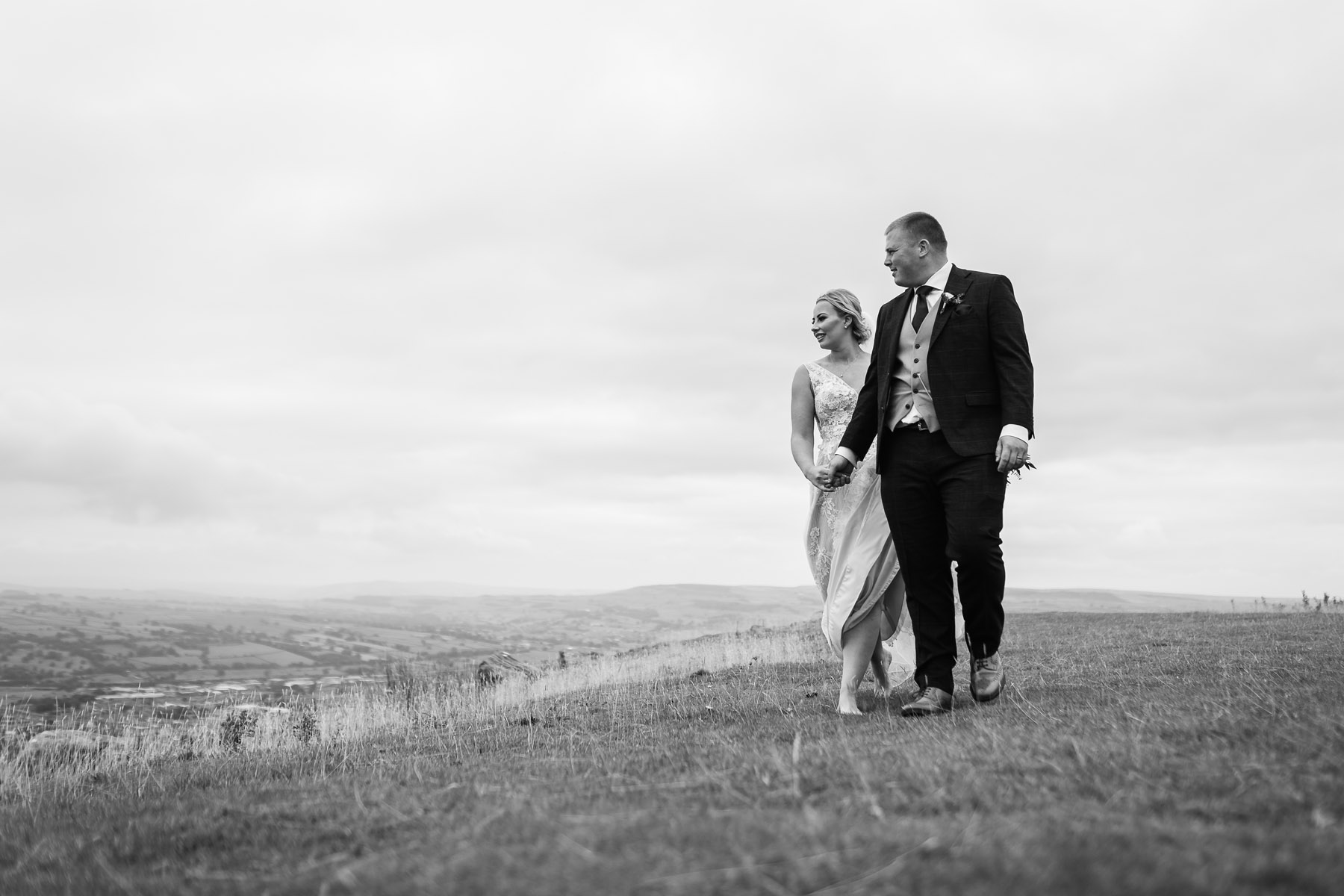 Bride and Groom walking on the moors at their Cowling Pinnacle Events Wedding 