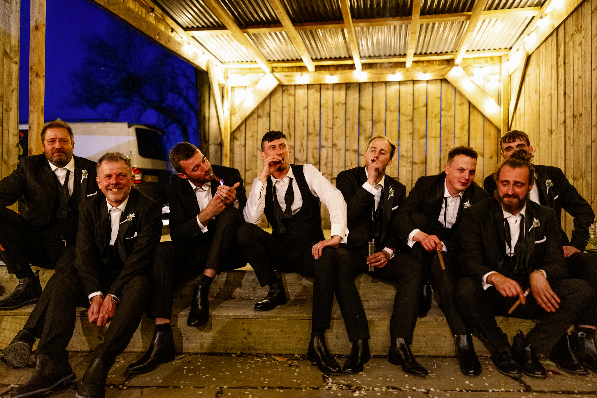 Groomsmen smoking cigars in Tuxedos 