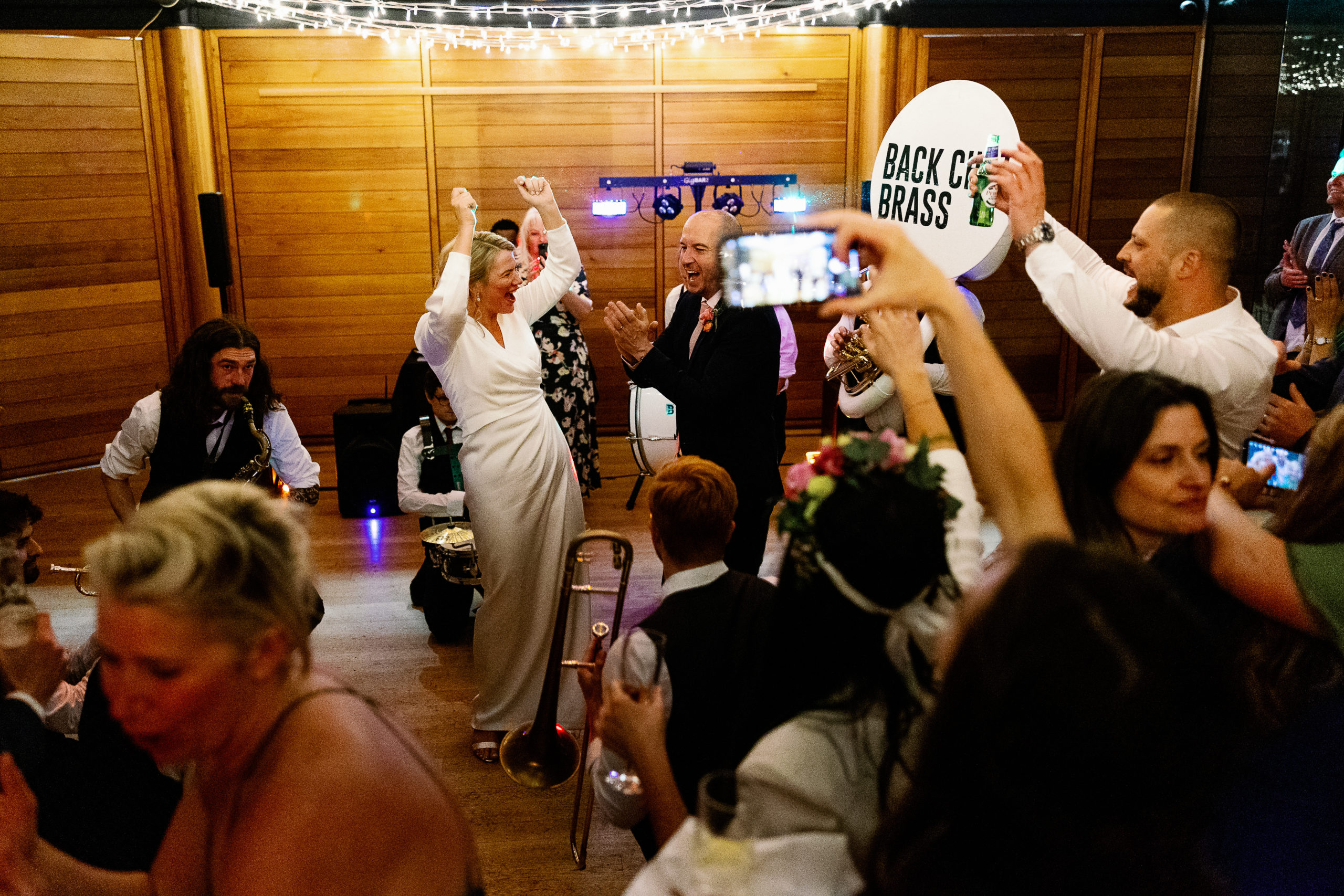 Bride and groom dancing to back chat brass