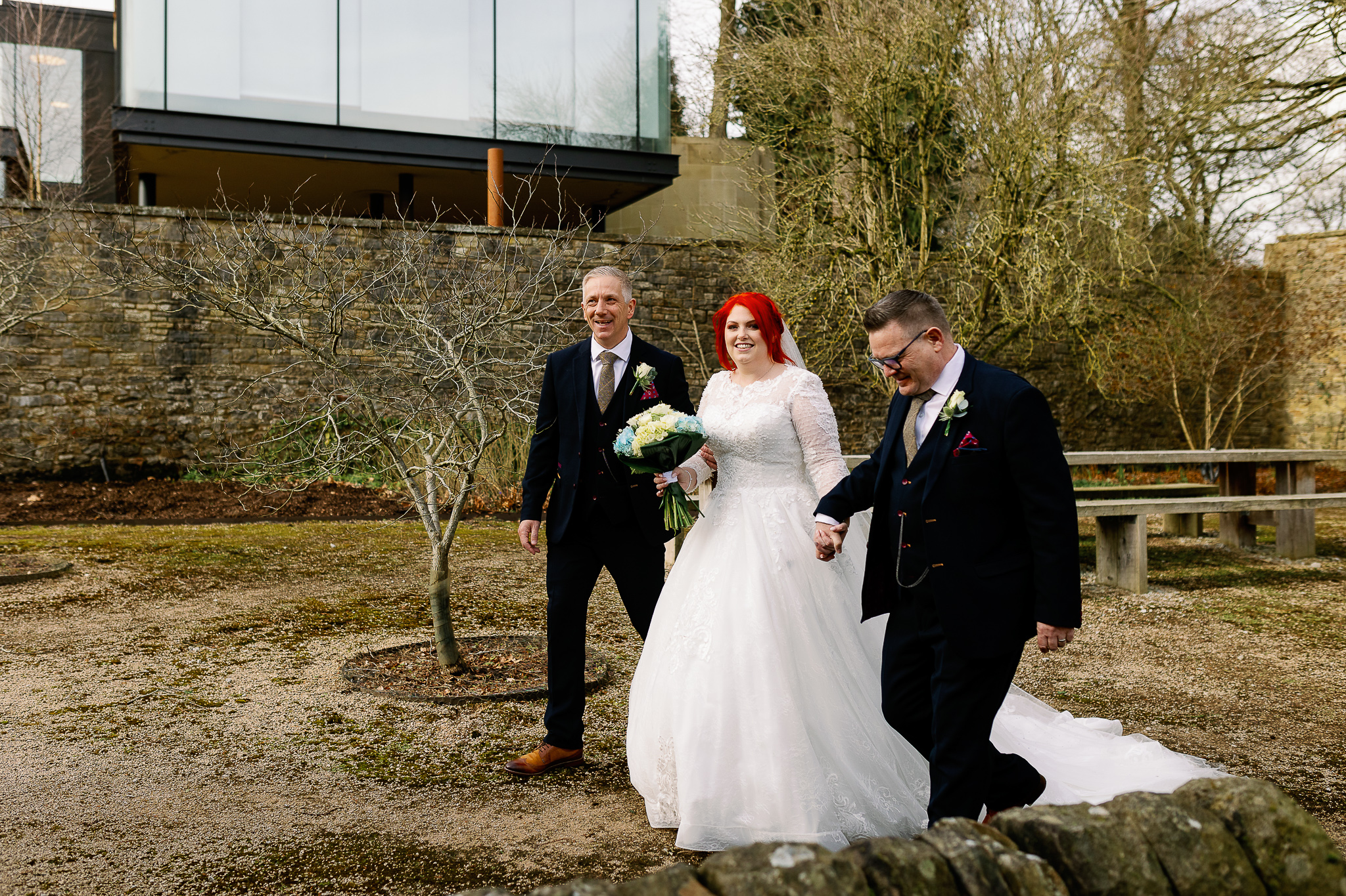 Bride walking to her outdoor ceremony at Utopia, Broughton Hall 