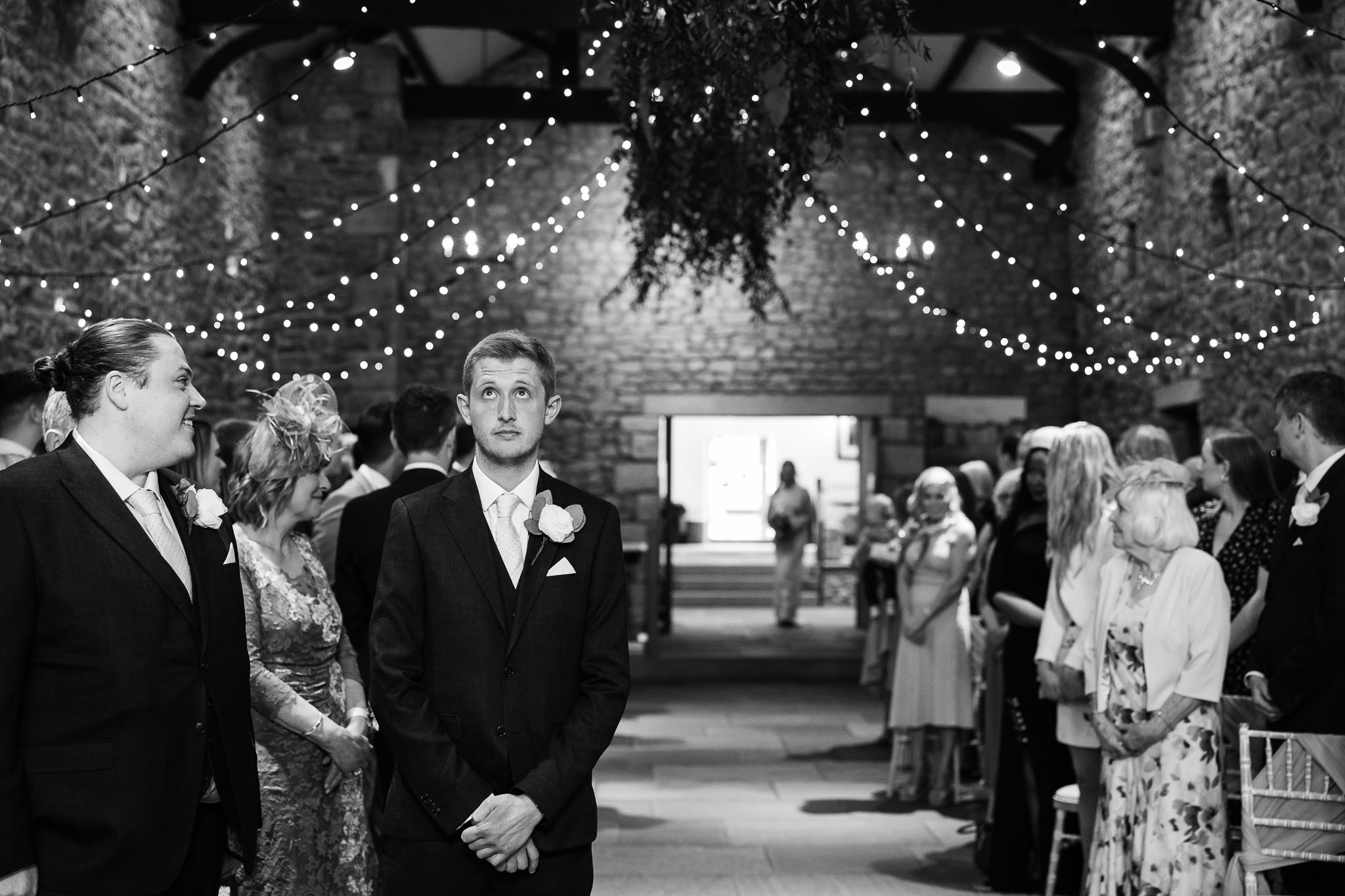 Groom nervously waiting for his bride at a barn wedding