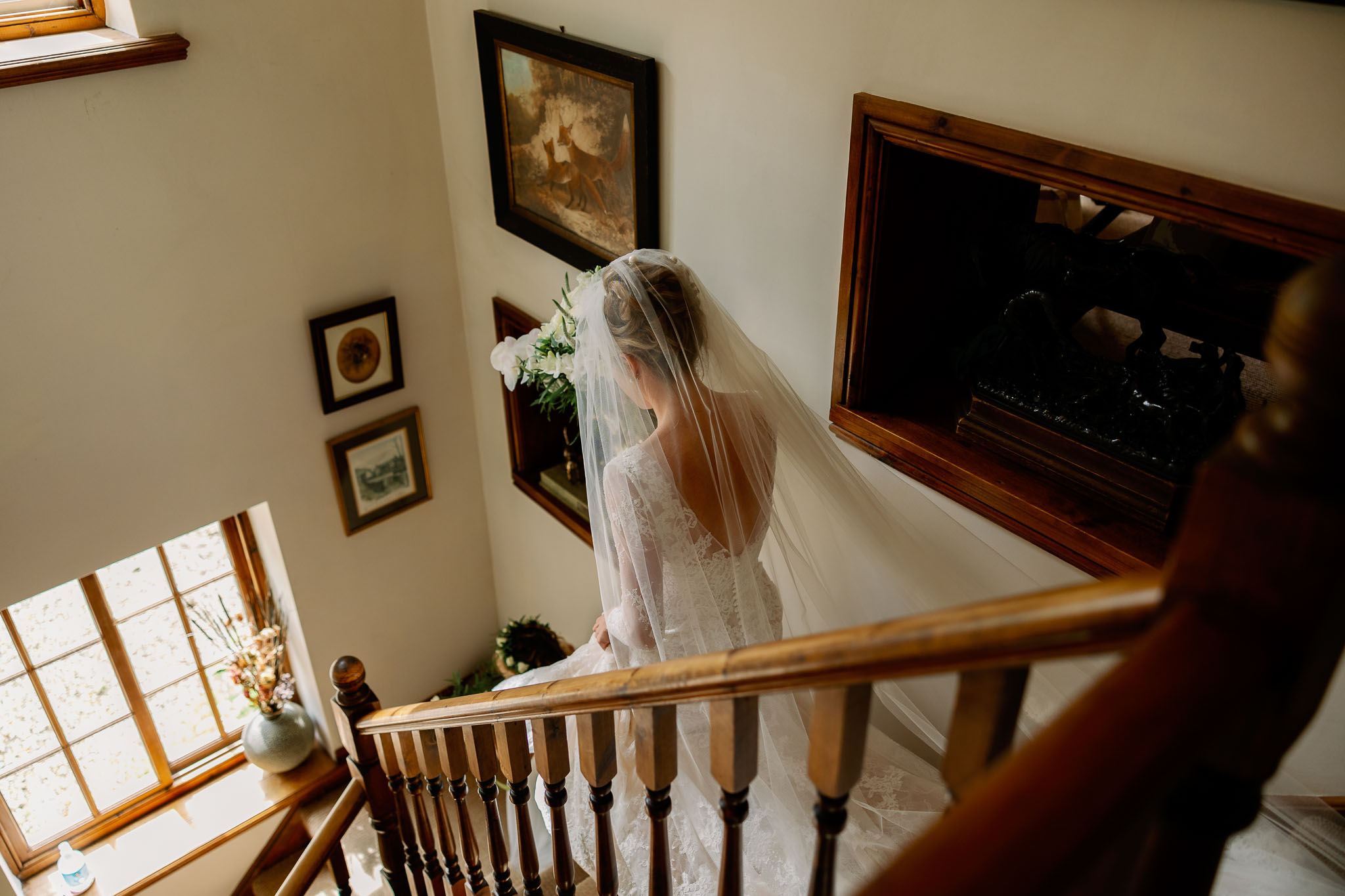 bride walking down stairs to her wedding at Jervaulx Abbey 