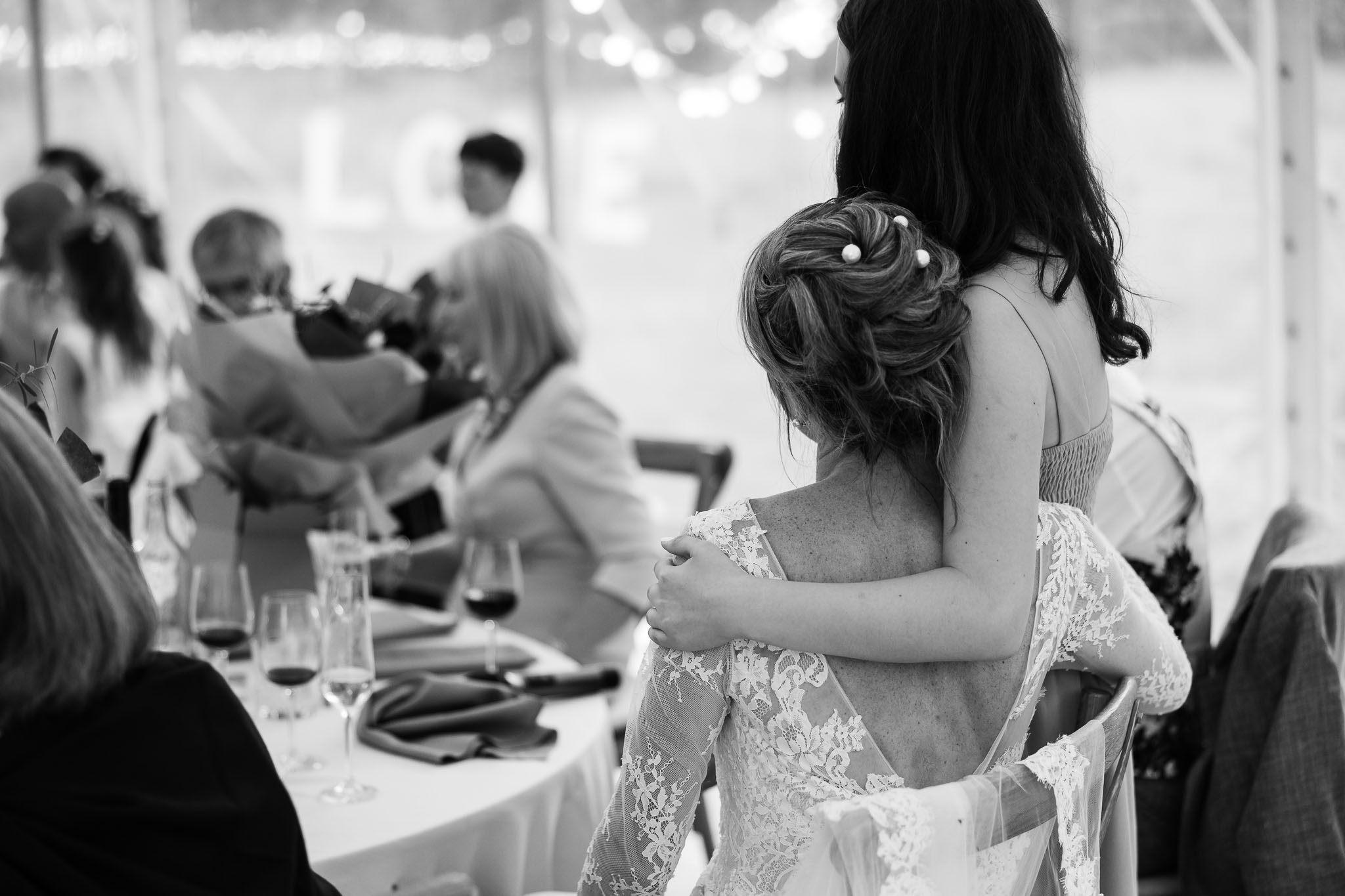 Mum bride and daughter on wedding day hugging 