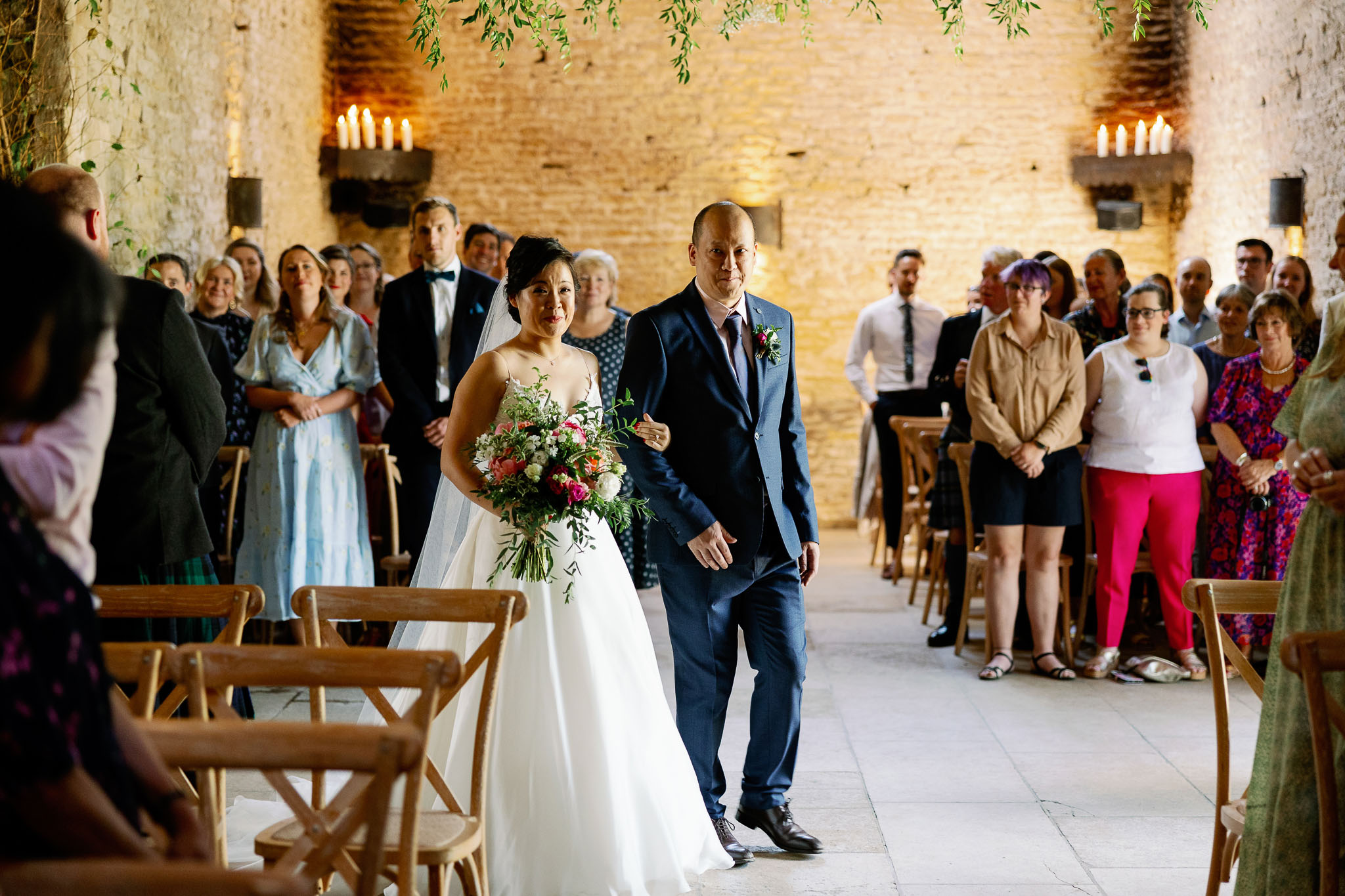 bride walking the aisle at the Stone Barn Wedding Venue in Gloucester