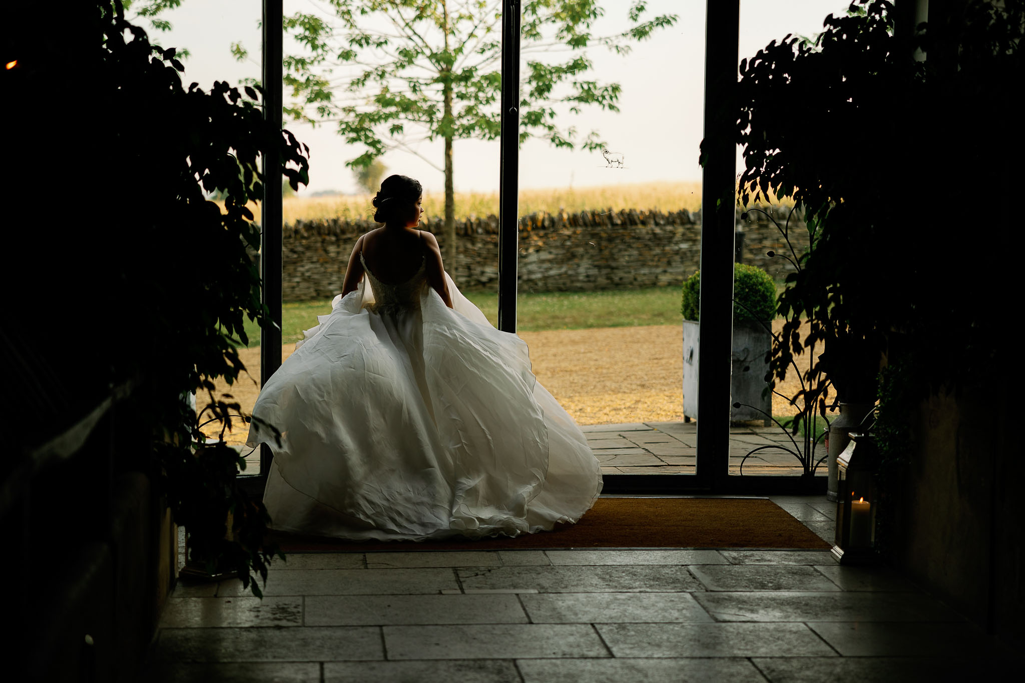 amazing picture of a bride with the wind blowing her wedding dress