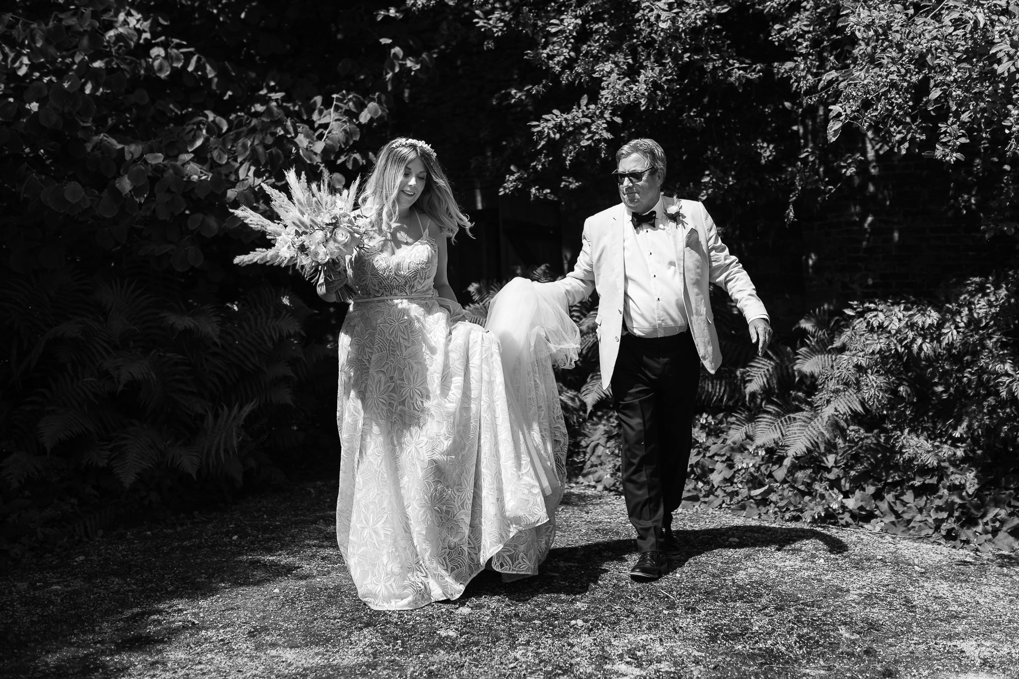 Dad carrying brides dress at Utopia Broughton Hall